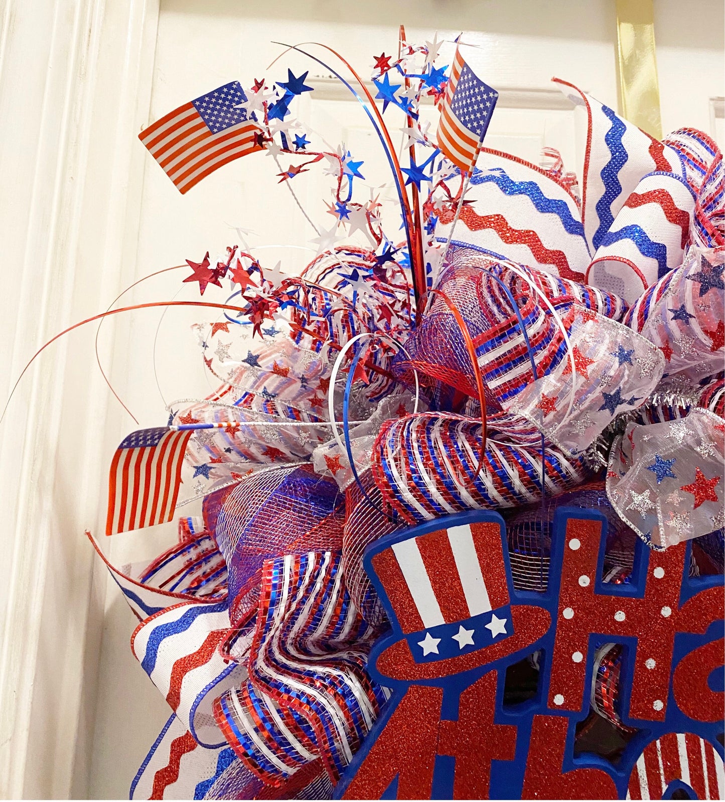 Decorative wreath with American flags, stars, and ribbons on a white background
