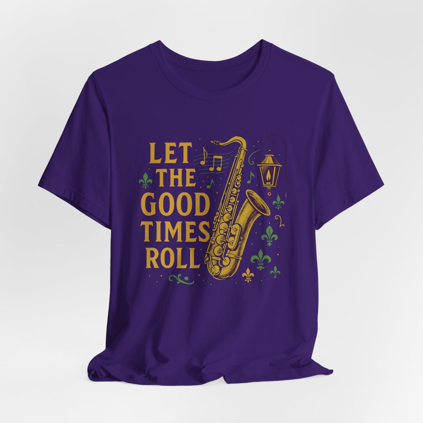 Purple t-shirt with a saxophone graphic and 'Let the Good Times Roll' text on a white background, hanging view