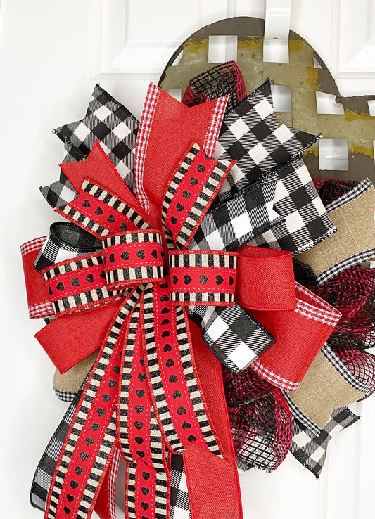 Decorative bow with red and black plaid patterns on a white background