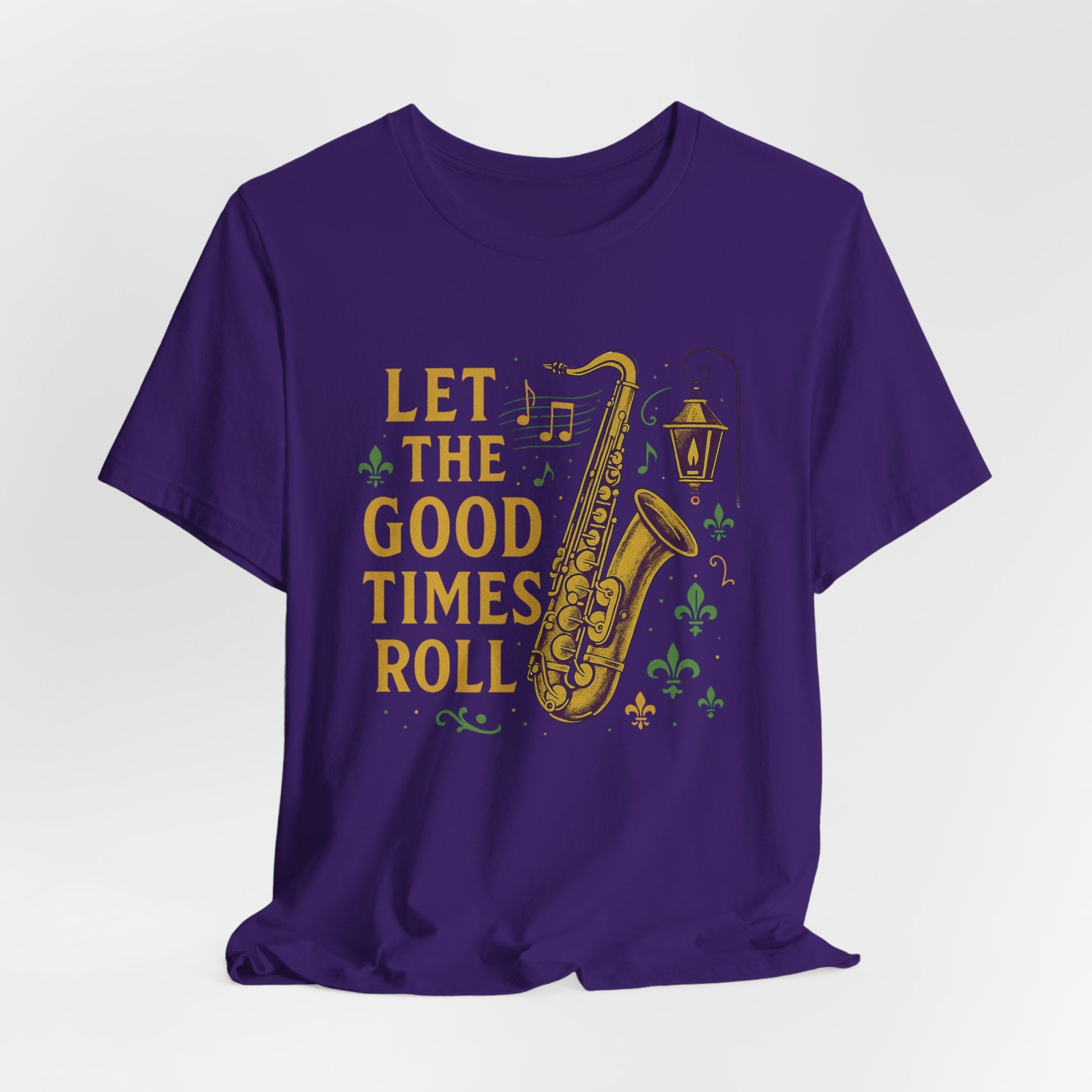 Purple t-shirt with a saxophone graphic and 'Let the Good Times Roll' text on a white background, hanging view