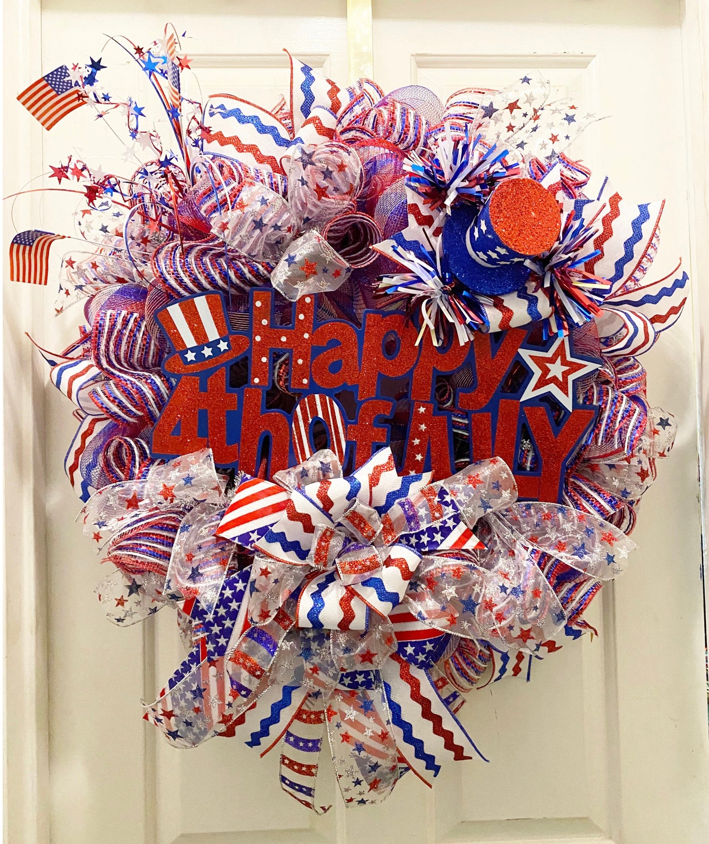 Decorative wreath with red, white, and blue colors, featuring 'Happy 4th of July' text.