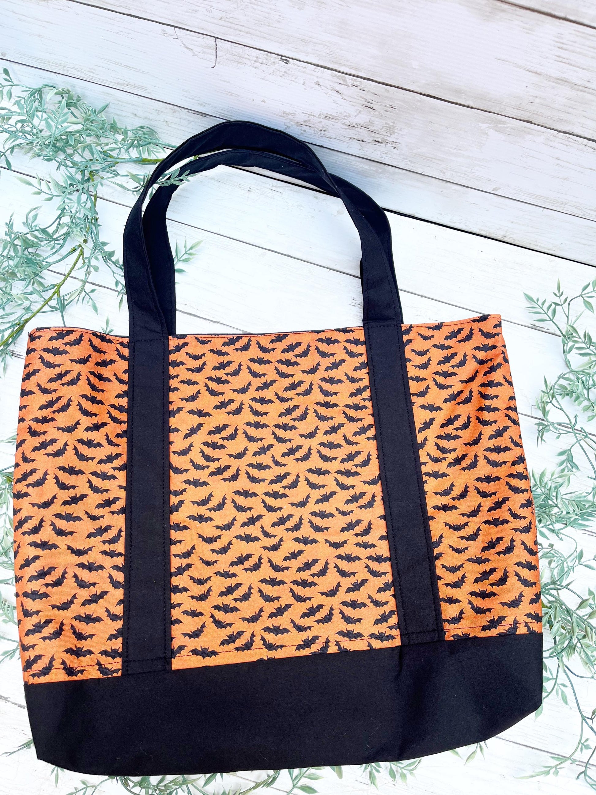 Tote bag with Halloween bat pattern on an orange background