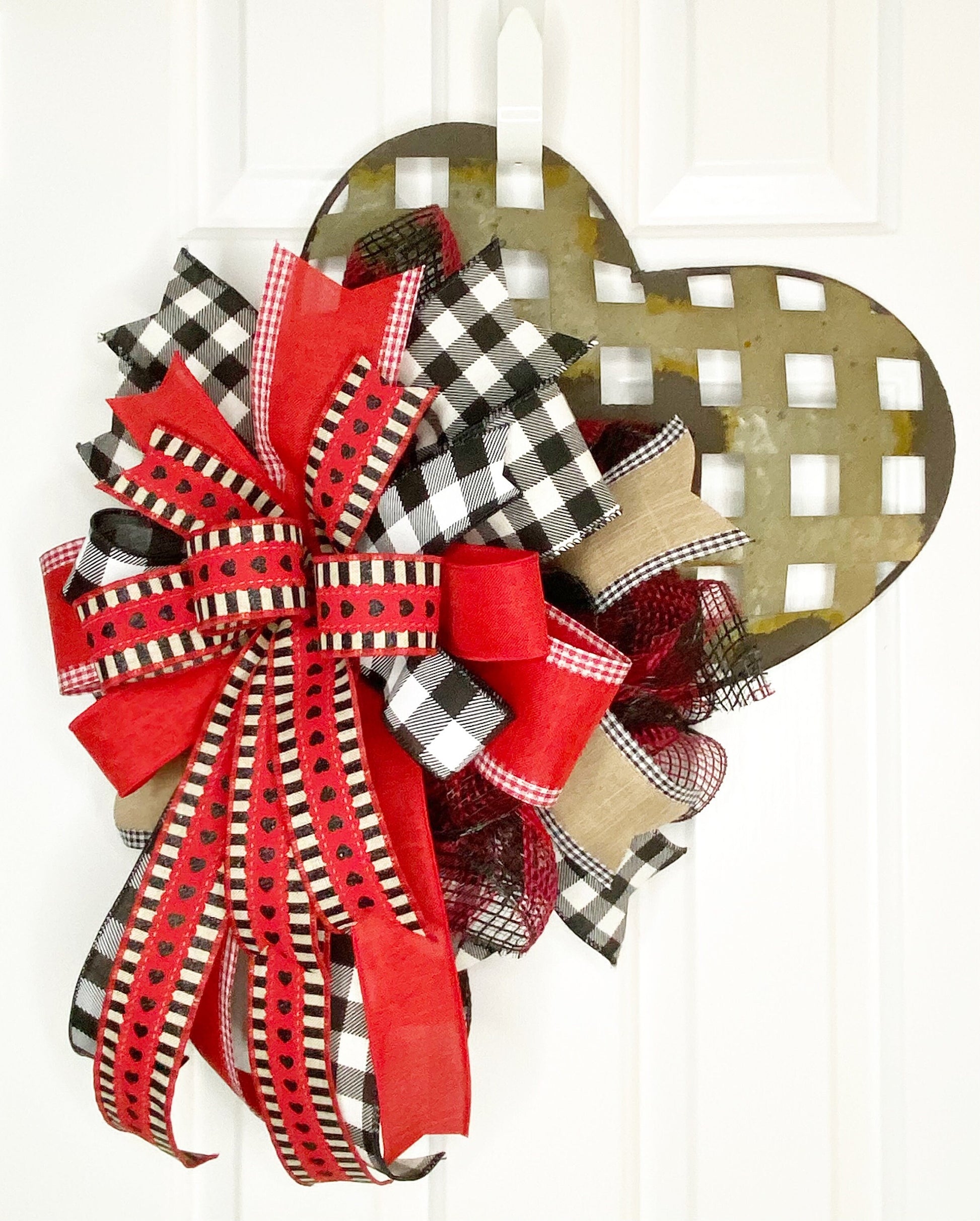 Decorative bow with red, black, and plaid patterns on a white background