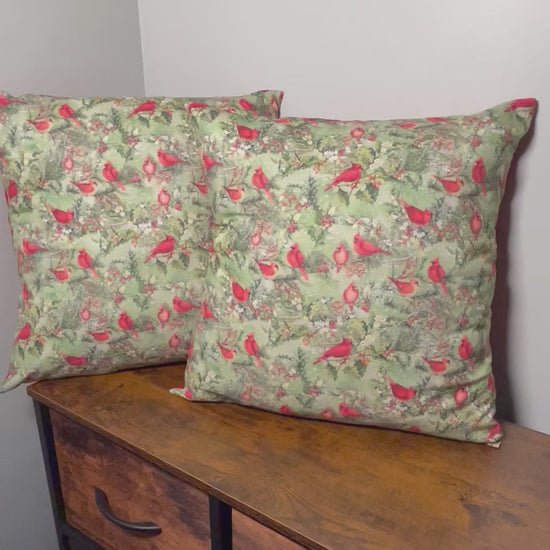 brief video showing details of 2 18 inch throw pillows of Christmas Cardinals on front and red backing on pillows