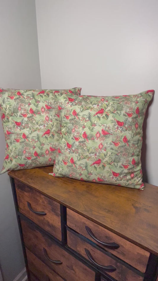 brief video showing details of 2 18 inch throw pillows of Christmas Cardinals on front and red backing on pillows