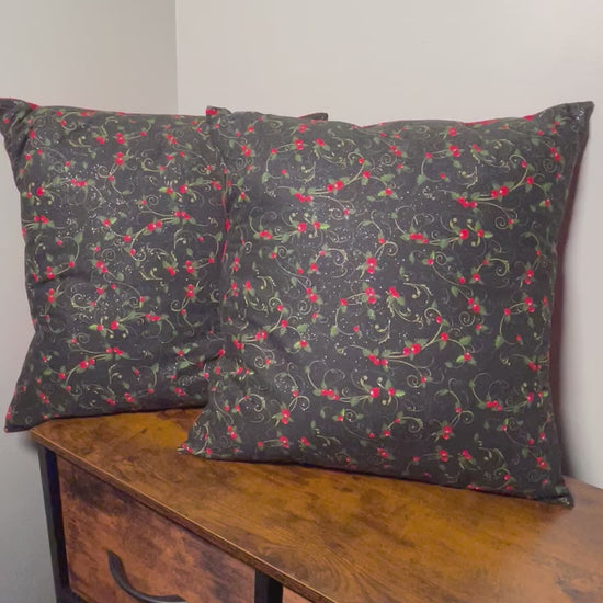 Brief video of 18 inch Christmas holly berry throw pillow with black background and red backing